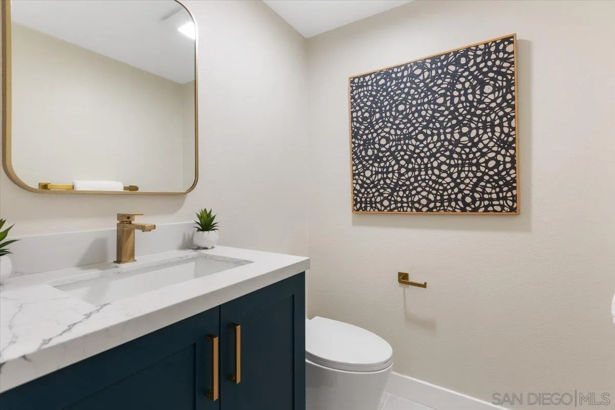 4692 Adra Way Oceanside, CA 92056 - Photo 16 of 51 a bathroom with a sink a toilet and a mirror