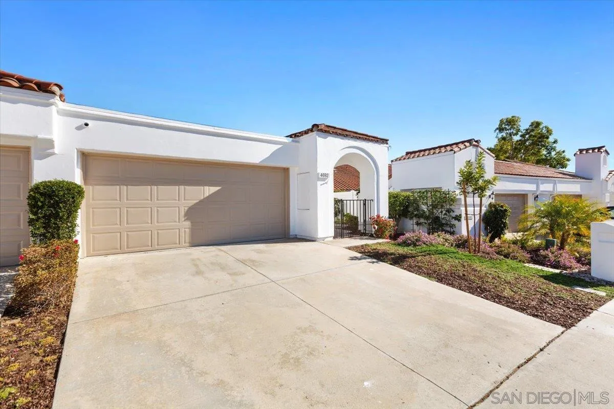 4692 Adra Way Oceanside, CA 92056 - Photo 40 of 51 a front view of a house with a yard and garage