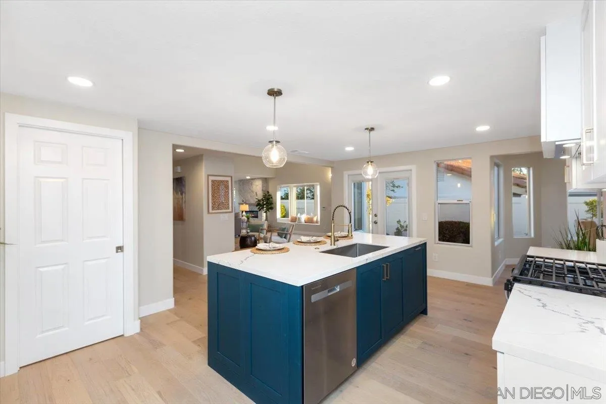 4692 Adra Way Oceanside, CA 92056 - Photo 4 of 51 a large kitchen with a counter top space a sink appliances and cabinets