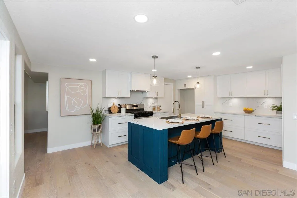 4692 Adra Way Oceanside, CA 92056 - Photo 6 of 51 a kitchen with a sink a counter top space and stainless steel appliances