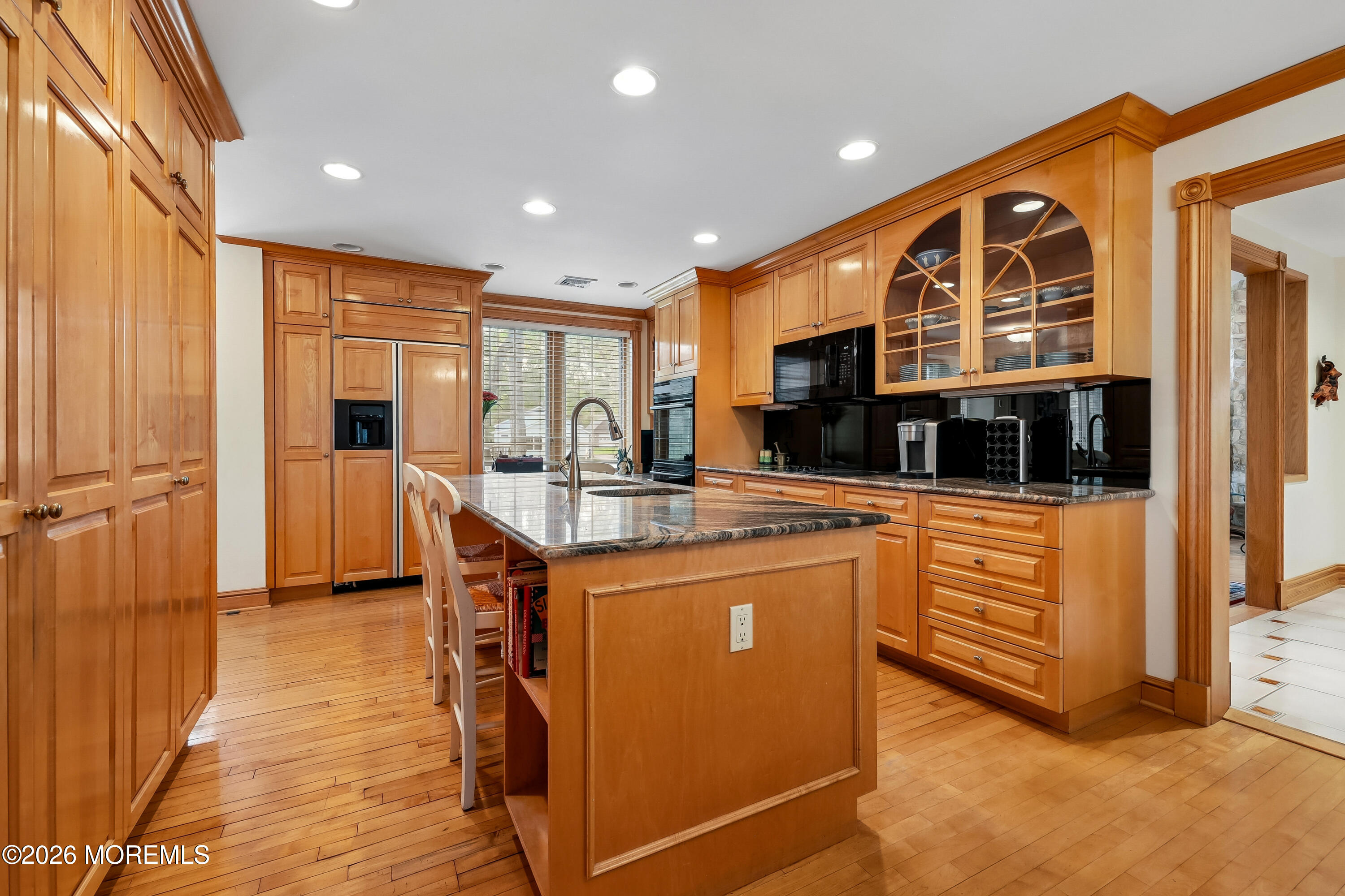 187 Hockhockson Road Colts Neck, NJ 07722 - Photo 18 of 55 a kitchen with stainless steel appliances granite countertop a refrigerator a oven a sink and a dining table with wooden floor