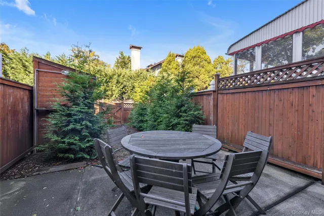 a view of a patio with table and chairs and potted plants