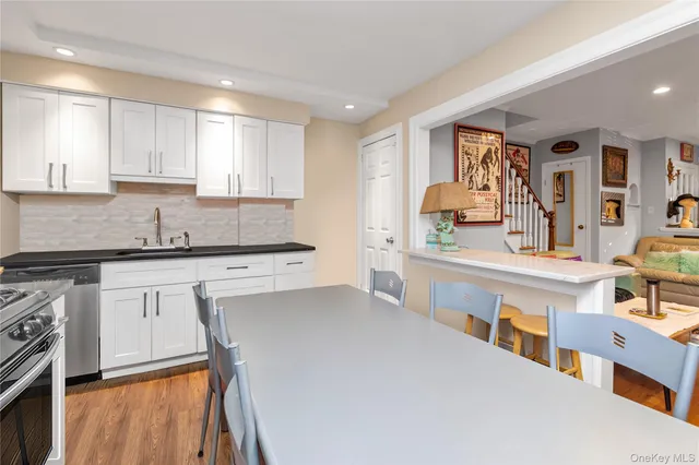 a kitchen with stainless steel appliances a sink stove and cabinets