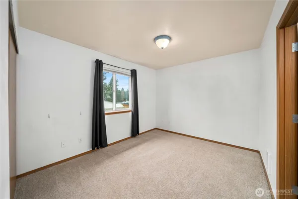 an empty room with windows and closet
