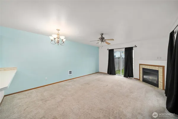 a view of an empty room with a fireplace