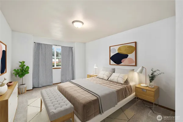 a bedroom with a bed and a potted plant