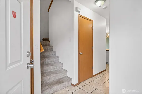 a view of a hallway with wooden cabinets and entryway