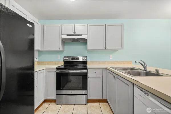 a kitchen with a sink and a stove top oven