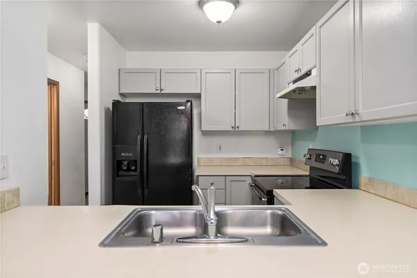 a kitchen with a sink and refrigerator