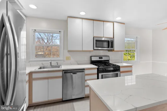a kitchen with a sink stove and refrigerator