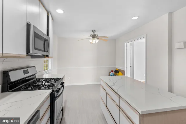 a kitchen with a sink a stove and cabinets