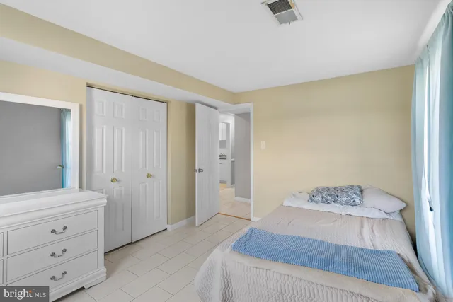 a bedroom with a bed and a dresser in it