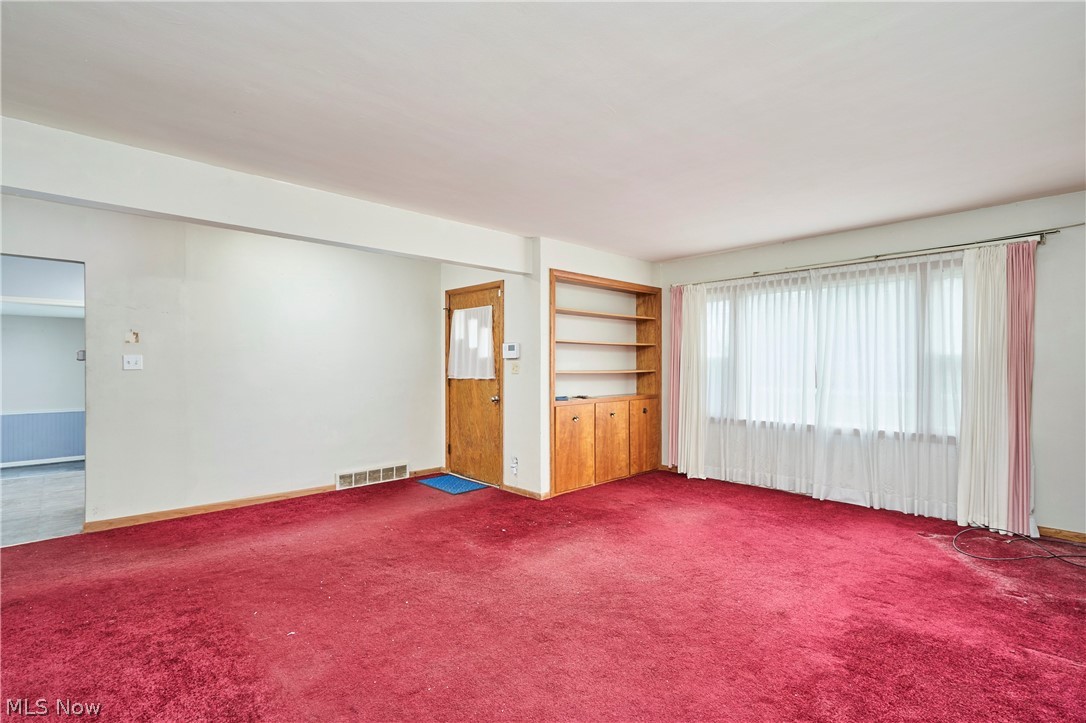 2941 Sweitzer Road Uniontown, OH 44685 - Photo 2 of 16 Unfurnished room with baseboards and carpet