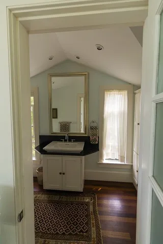 a bathroom with a sink a mirror and a toilet