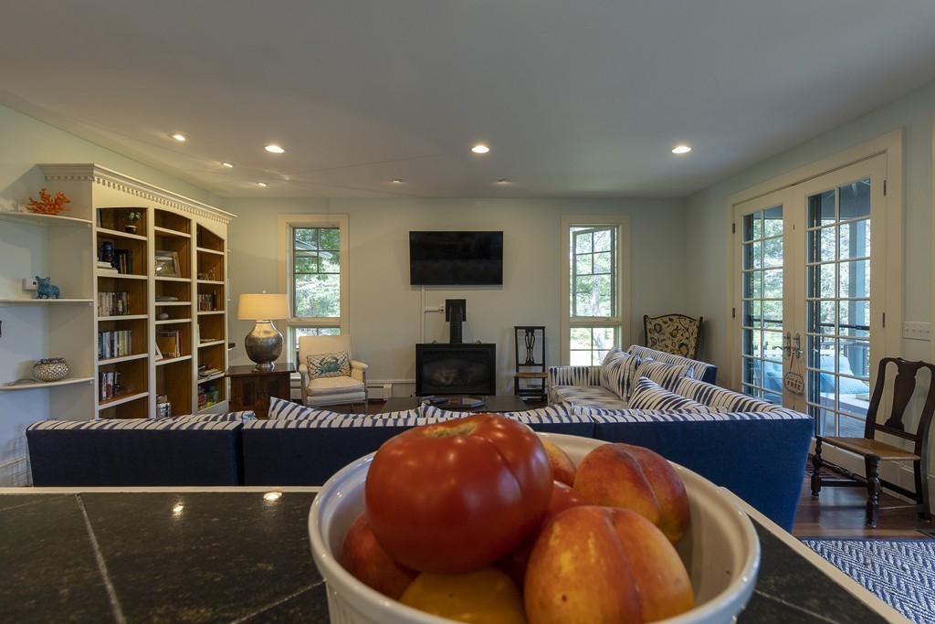 101 Associates Road Falmouth, MA 02540 - Photo 10 of 19 a living room with furniture a fireplace and a flat screen tv