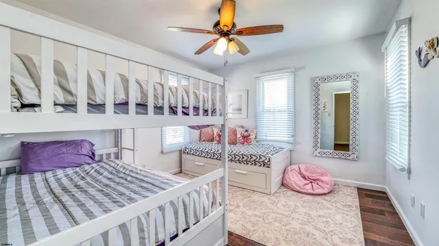 a bedroom with bed and wooden floor