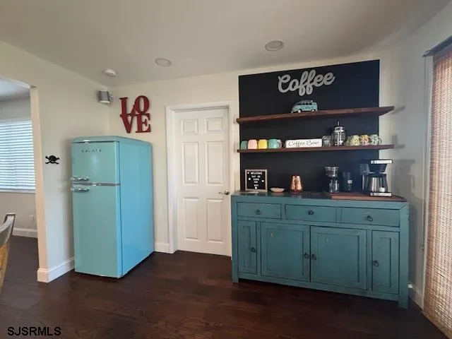 a dining room with furniture a window and wooden floor