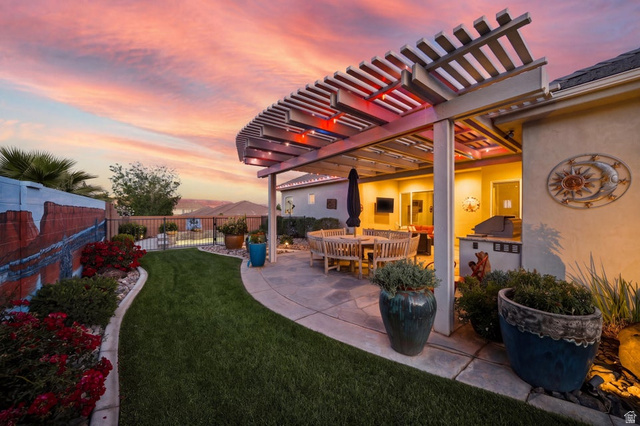 2829 East 1880th Street South St. George, UT 84790 - Photo 49 of 54 Yard at dusk featuring a patio, a fenced backyard, a pergola, and outdoor dining area