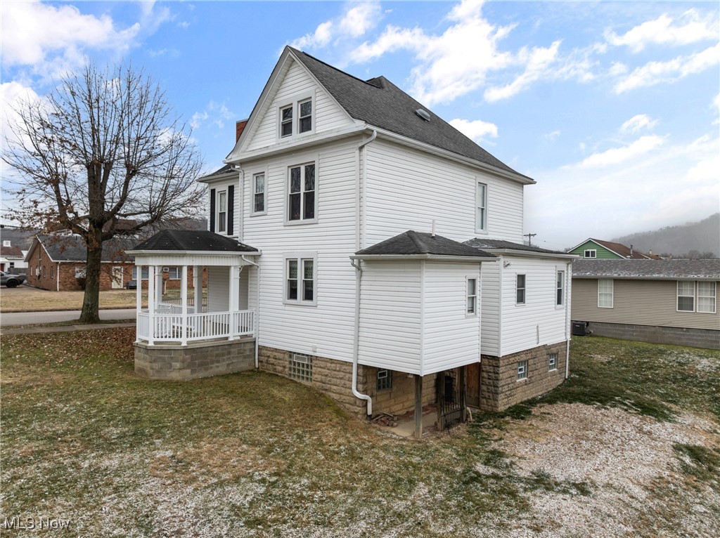 1011 Parriott Avenue Moundsville, WV 26041 - Photo 32 of 44 View of home's exterior featuring a yard, roof with shingles, and a patio area