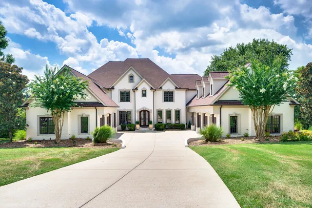 a view of a dining room with furniture and a chandelier