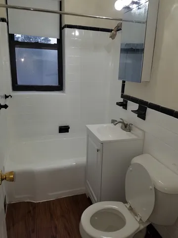 a bathroom with a toilet a sink and bathtub
