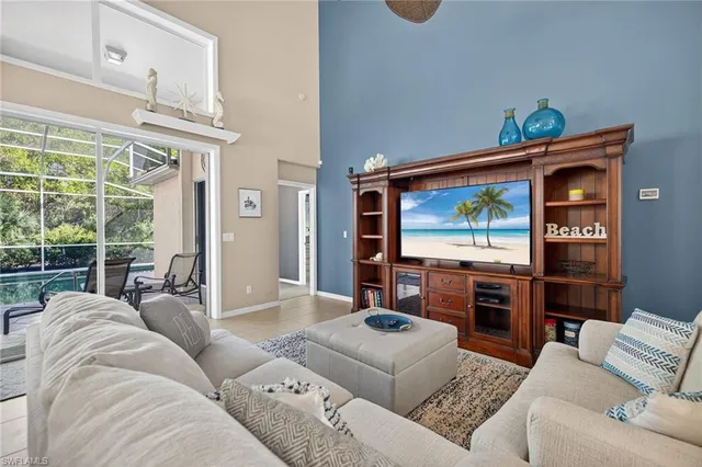a living room with furniture and a floor to ceiling window