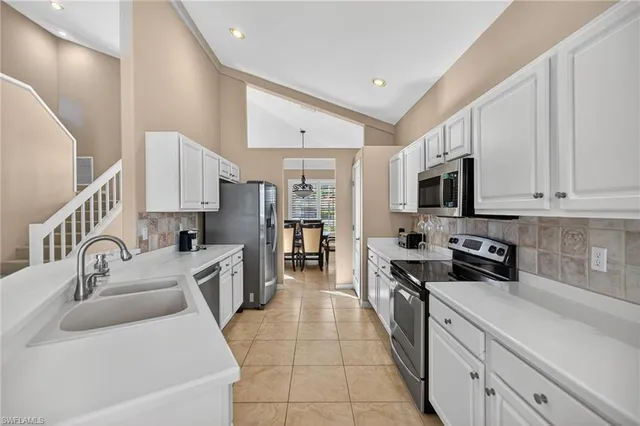 a kitchen with stainless steel appliances granite countertop a sink and cabinets