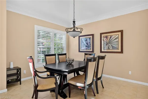 a dining room with furniture and window