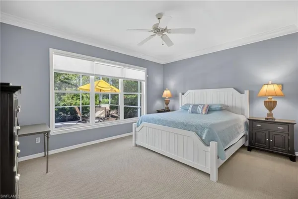 a bedroom with a large bed and a large window