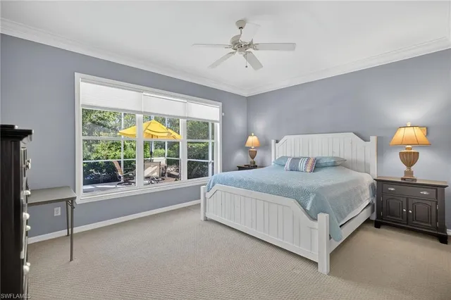 a bedroom with a large bed and a large window