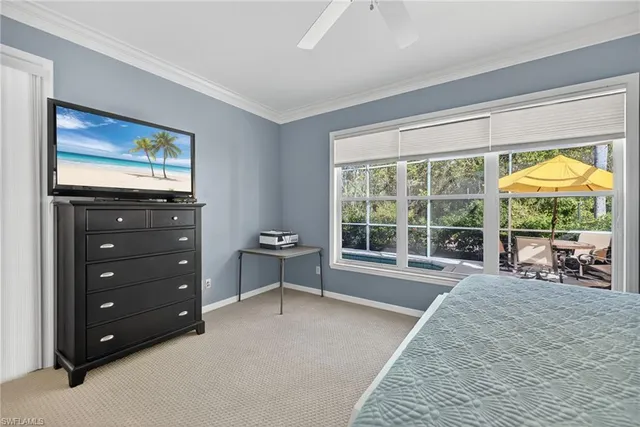 a spacious bedroom with a bed and a large window