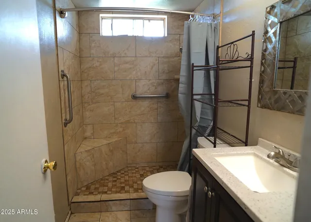 a bathroom with a sink toilet and shower
