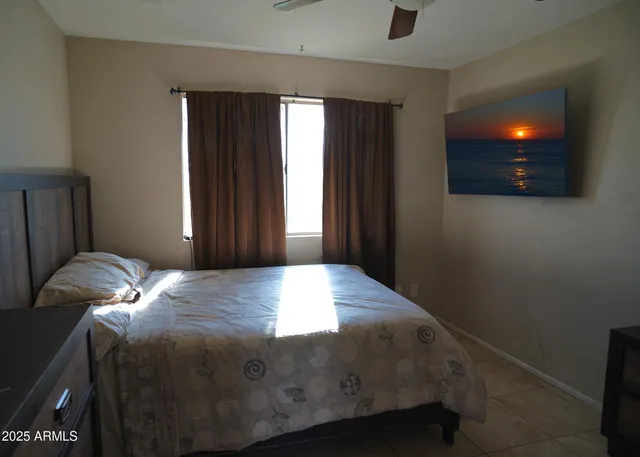 a bed sitting in a bedroom next to a window