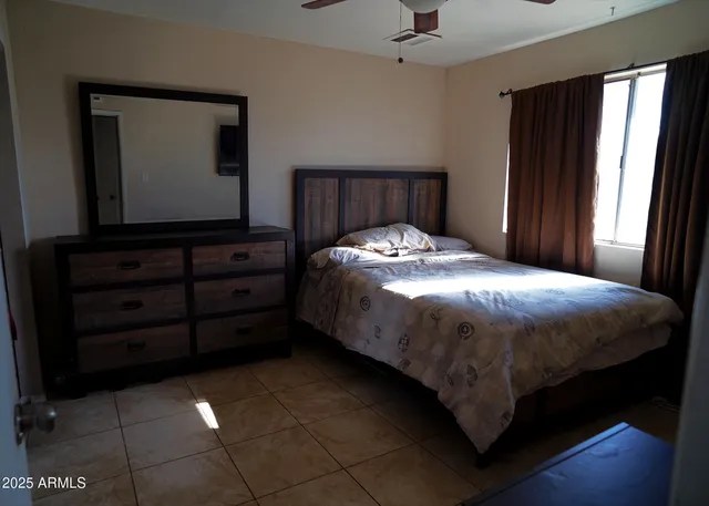 a bedroom with a bed and a window