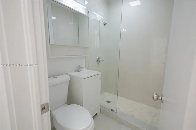 a white toilet sitting next to a bathroom sink