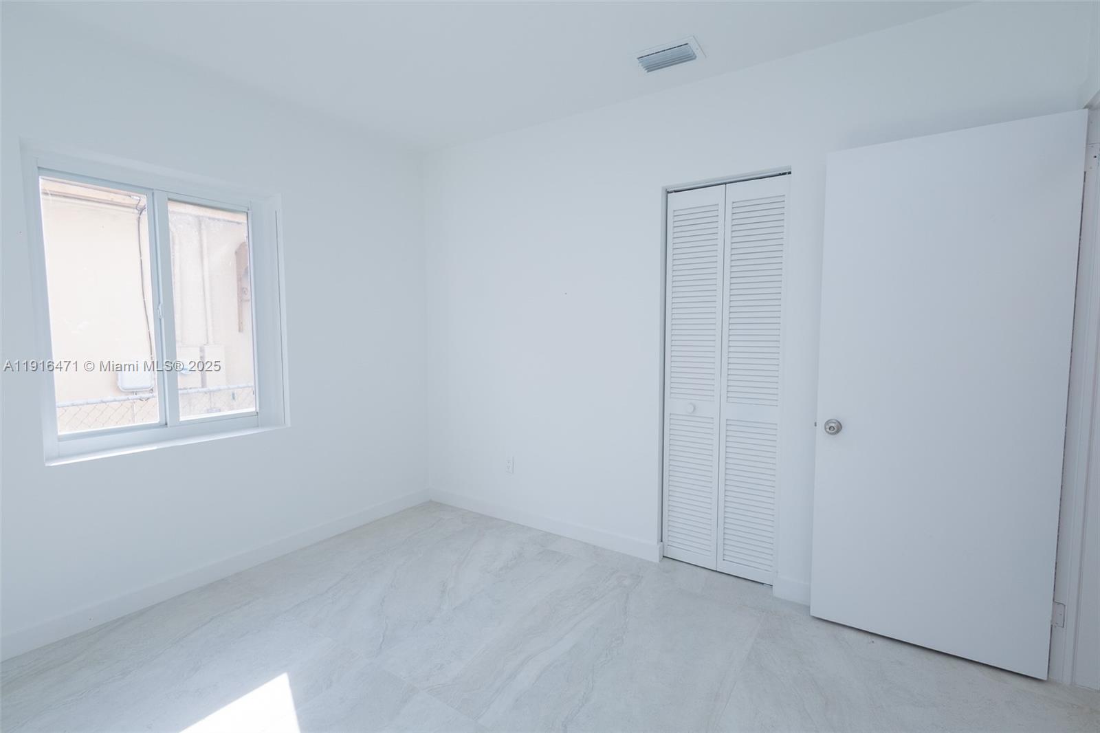 2675 Southwest 24th Terrace Miami, FL 33145 - Photo 25 of 36 a view of an empty room with a window