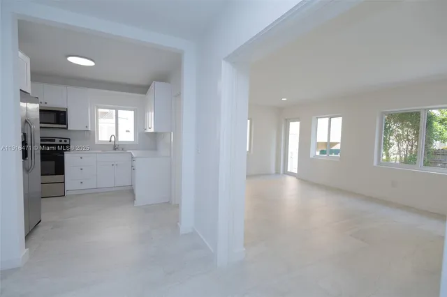 a kitchen with cabinets and stainless steel appliances