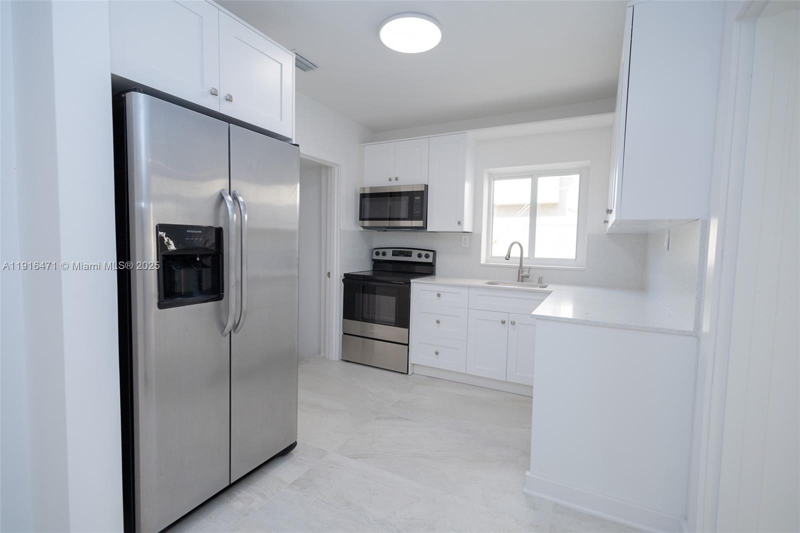 2675 Southwest 24th Terrace Miami, FL 33145 - Photo 8 of 36 a kitchen with cabinets and stainless steel appliances