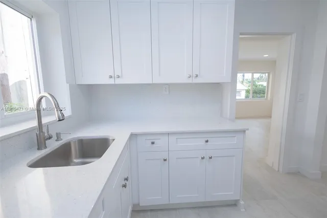 a kitchen with a sink and cabinets