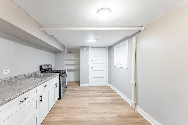 a large kitchen with a stove and refrigerator