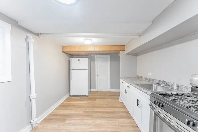 a kitchen with a stove and a white cabinet