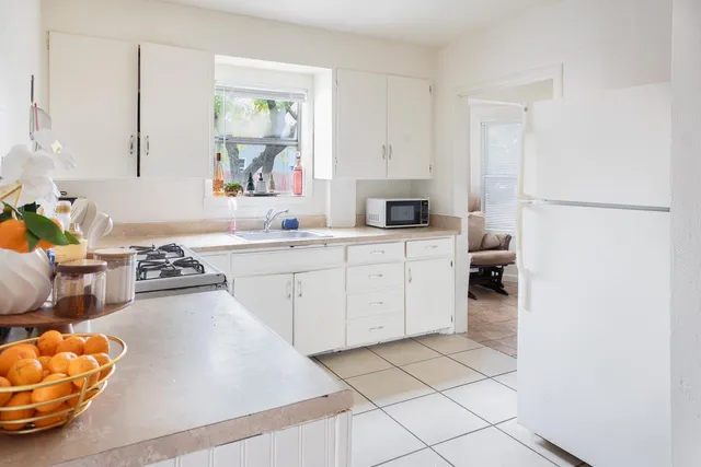 a kitchen with a sink appliances and cabinets
