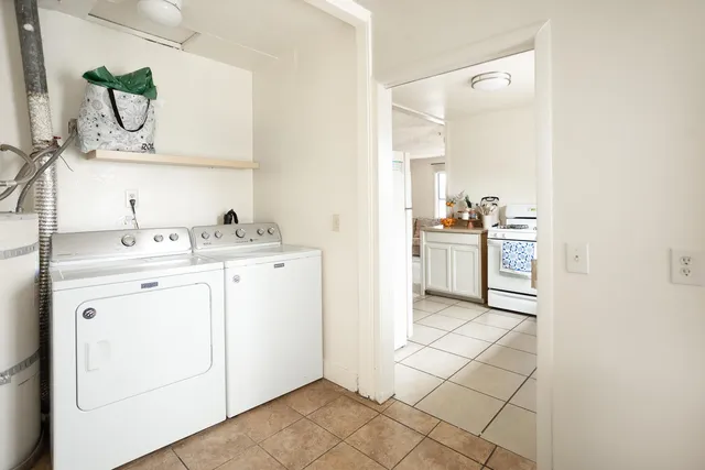 a utility room with cabinets washer and dryer