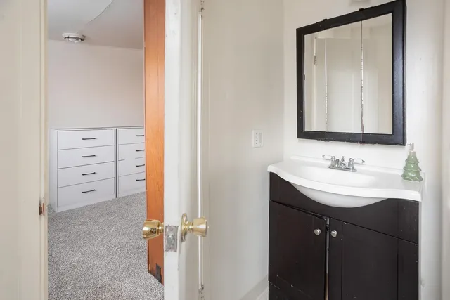 a bathroom with a sink vanity and a mirror