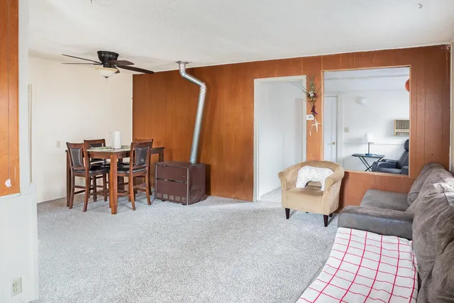 a living room with furniture and a chandelier
