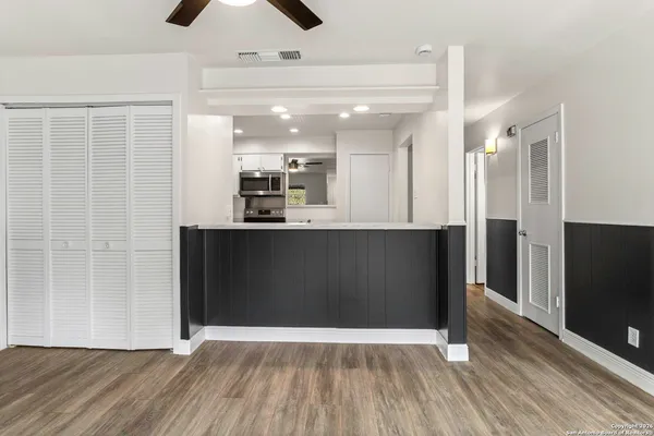 a view of a kitchen with wooden floor and a sink