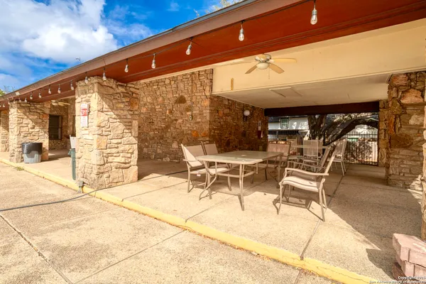 a patio with table and chairs