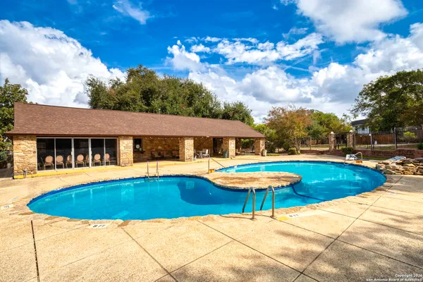 a view of a house with swimming pool and sitting area