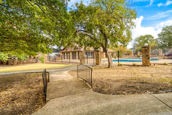 a view of a yard with wooden fence
