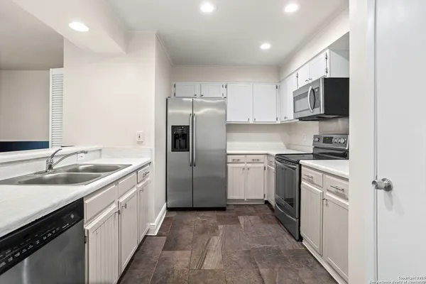 a kitchen with a sink stove and refrigerator